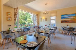 Breakfast room interior with laid tables and chandelier